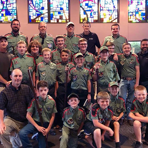 Trail Life USA Troop of fathers and sons posing in a church sanctuary